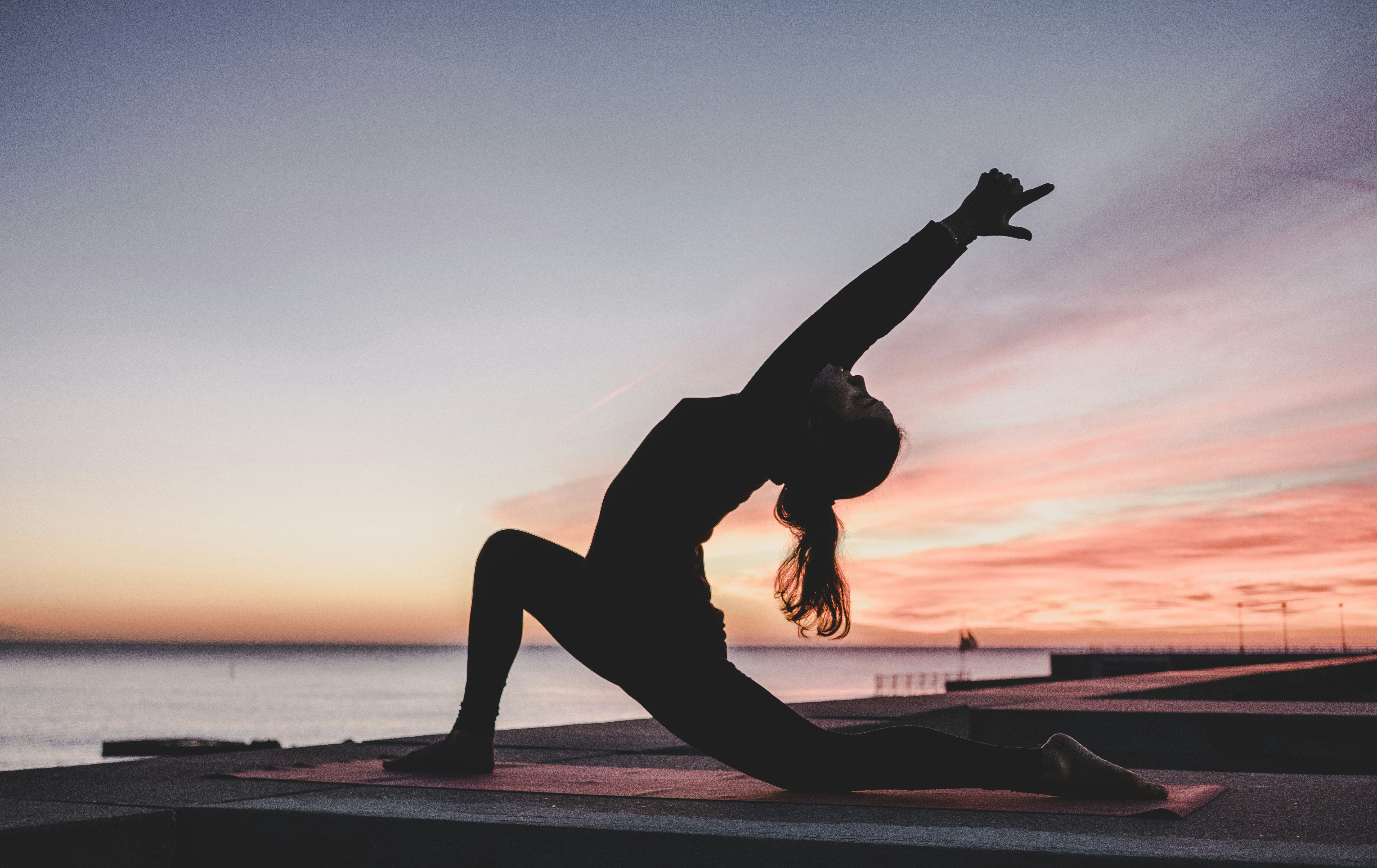 woman practicing yoga on virgin voyages cruise