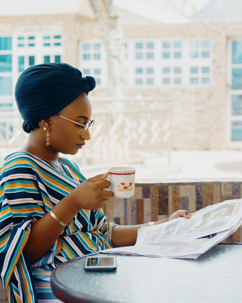 black woman sitting in the cafe, practicing self-care 