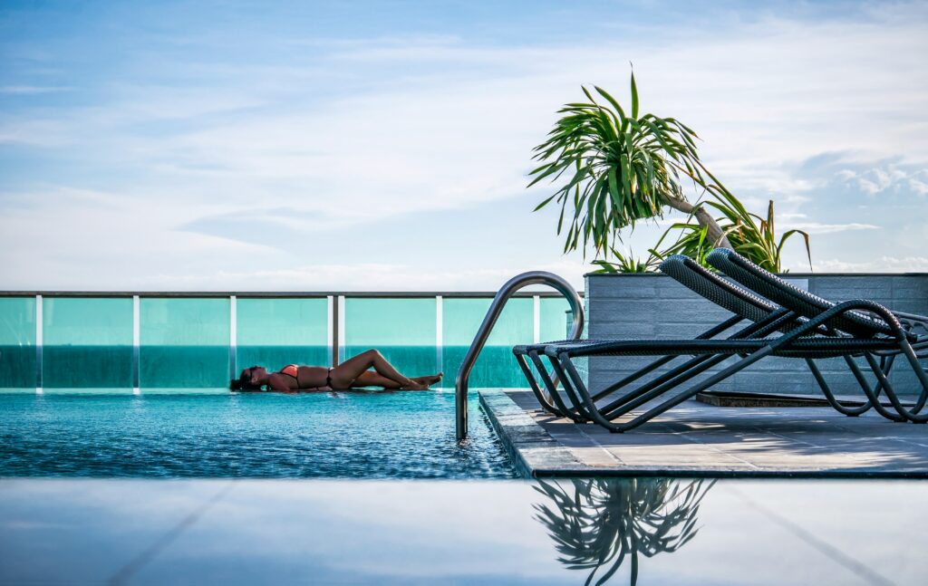 black women laying near pool, 